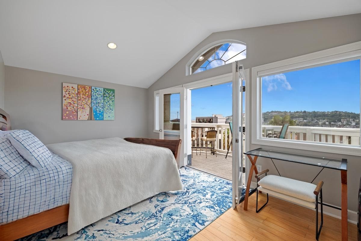 The primary suite features French doors that open to breathtaking panoramic views from your private balcony. Enjoy quality linens on a king memory foam mattress, heated floors, A/C, and a bathroom complete with a jetted tub and a dual-headed shower.